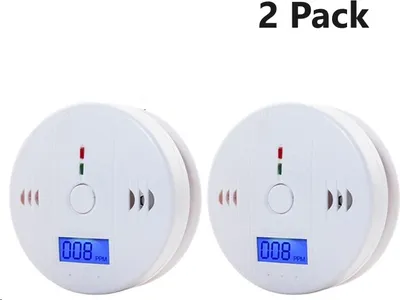Two white carbon monoxide detectors are shown against a white background.