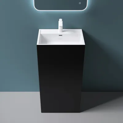 A modern black pedestal sink with a white basin is shown against a blue wall.
