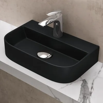 A black ceramic washbasin with a chrome faucet is placed on a marble countertop.