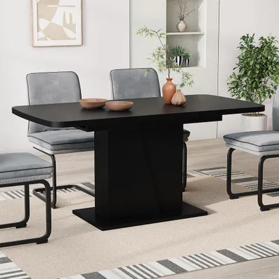 A dining room scene with a black extendable dining table and gray chairs.