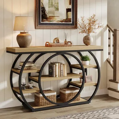 A console table with shelves is displayed in a hallway setting, decorated with books, a lamp, and decorative items.