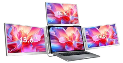 A laptop with three additional screens attached, displaying colorful abstract images.