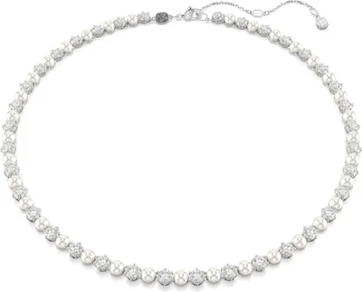 A close-up studio shot of a pearl and diamond tennis necklace on a white background.