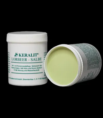 Two tubs of Keralit Lorbeer-Salbe on a black background. One tub is upright and the other is open and tilted.