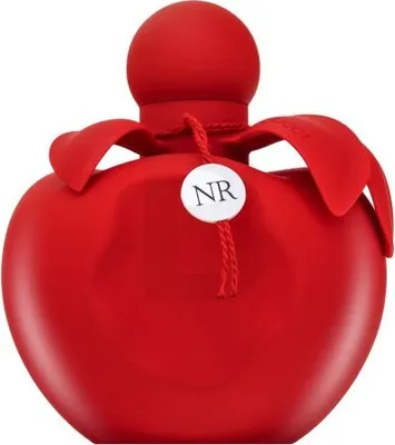 A red perfume bottle with a round cap and petal-like accents around the neck. A small white tag with 'NR' printed on it hangs from the neck with a string.