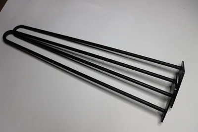 Three black hairpin legs are laid out on a white surface.