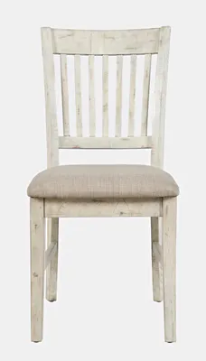 A front view of a distressed white wooden dining chair with a tan fabric seat.