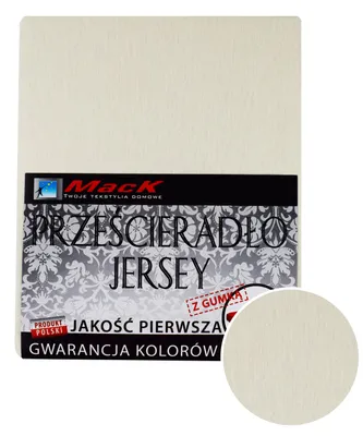 A flat lay of a cream-colored jersey fitted sheet with a label.