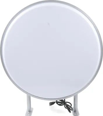 A round, double-sided LED lightbox sign with a silver frame and a white illuminated surface, mounted on two silver brackets. A black power cord is visible at the bottom.