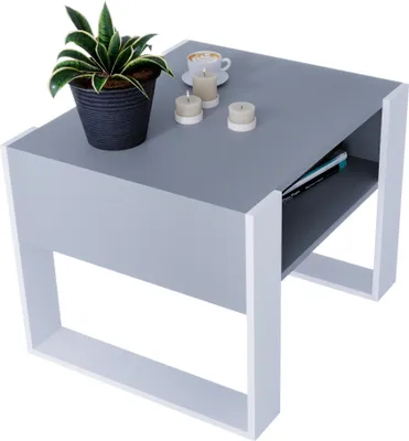 A modern, rectangular coffee table with a gray top and white legs, featuring a small plant, three candles, and a cup of coffee on top, and books on a shelf below.