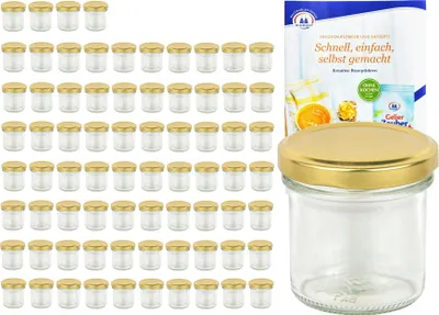 A collection of small glass jars with gold lids, along with a package of recipe cards.