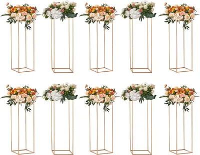 A collection of gold geometric stands topped with floral arrangements.