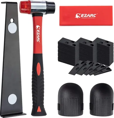 A flat lay of a flooring installation tool kit on a white background.