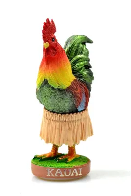 A figurine of a rooster wearing a grass skirt and standing on a base with the word "KAUAI" on it.
