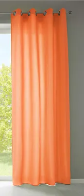 A single orange curtain hanging in front of a window.