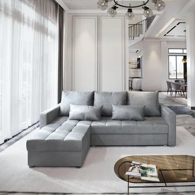 A modern living room with a grey sectional sofa and a coffee table.
