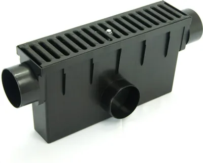 A black drainage channel with a grate on top and two side outlets, isolated on a white background.