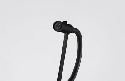 A close-up studio shot of a black faucet head and neck against a white background.