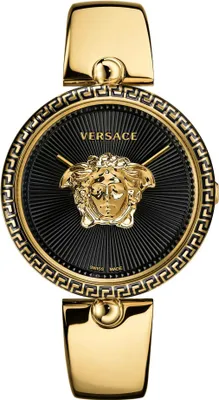 A close-up studio shot of a gold Versace watch with a black dial.
