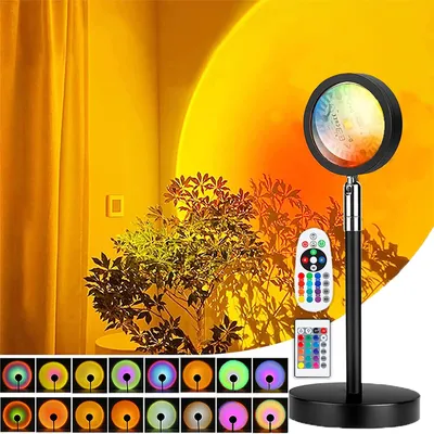 A sunset lamp is shown projecting a warm, colorful light onto a wall, with a plant casting shadows. Several smaller images at the bottom display different color options and modes of the lamp.