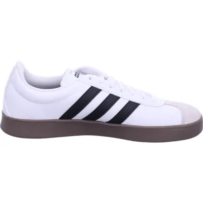 A side view of a white Adidas sneaker with black stripes and a brown sole.