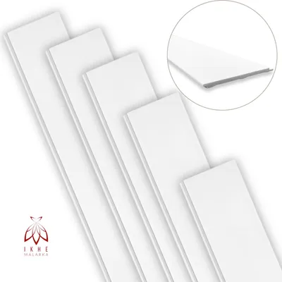 Several white wall panels are arranged diagonally on a white background, with a close-up inset showing the edge detail of one panel.