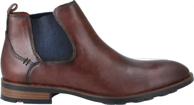 A side view of a brown leather Chelsea boot with a blue elasticated side panel.