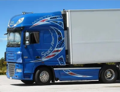 A blue semi-truck with American flag-themed graphics.