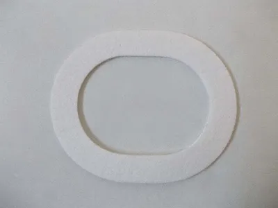 A white oval gasket on a light gray background.
