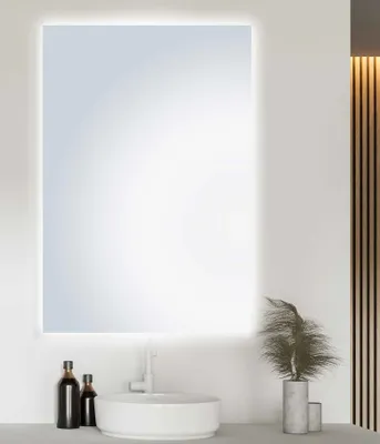 A modern bathroom vanity with a sink, faucet, mirror, and decorative items.