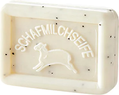 A bar of white soap with embossed text and a sheep illustration.