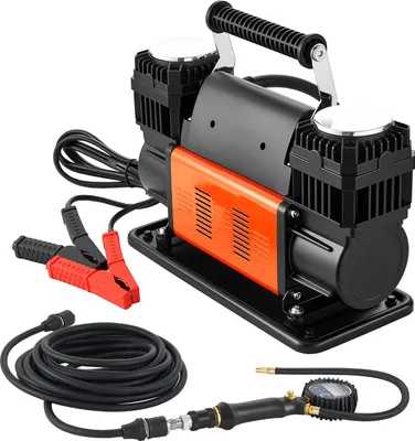 A portable dual-cylinder air compressor with its accessories, including jumper cables, a hose, and a digital tire pressure gauge, displayed on a white background.