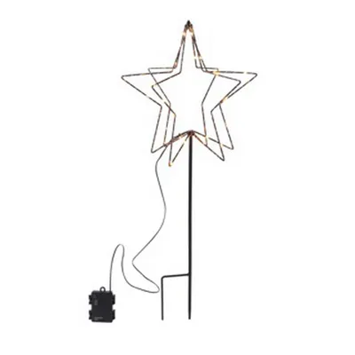 A decorative star-shaped light fixture with multiple layers, illuminated by warm white LEDs, mounted on a black stake with a battery pack at its base.