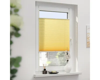 A yellow pleated blind is installed on a window.