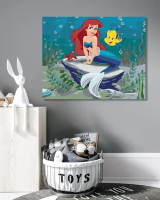 A child's room with a diamond painting of Ariel and Flounder on the wall, and a toy basket in the foreground.