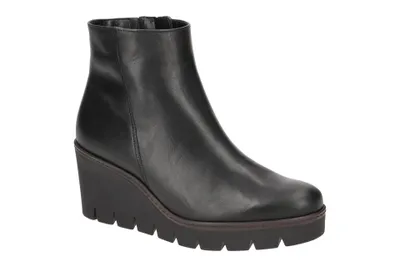 A black wedge bootie is shown against a white background.