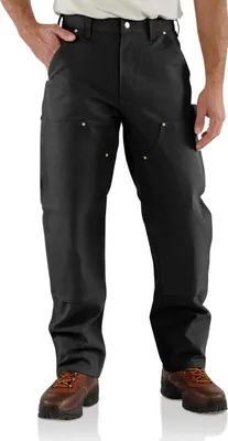 A person wearing black work pants and brown work boots, standing against a white background.