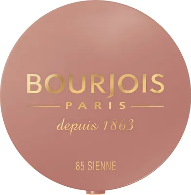 A top-down view of a round makeup compact with brand and product information printed on the lid.
