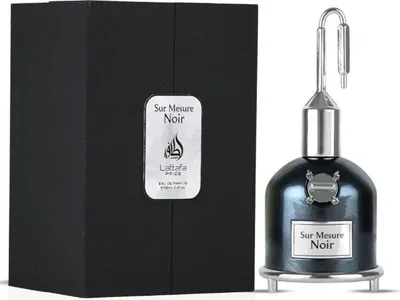 A perfume bottle and its packaging are displayed against a white background.