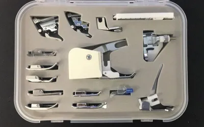 A set of sewing machine presser feet in a plastic storage case.