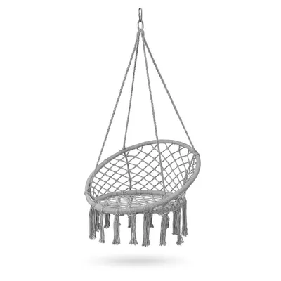 A hanging macrame chair with fringe detail, suspended against a white background.
