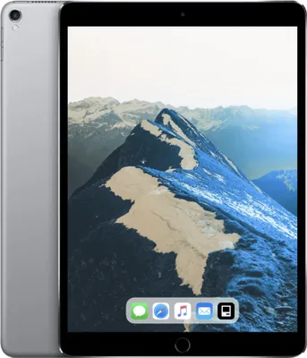 A silver iPad Pro is shown from the front and side, displaying a mountain landscape on its screen.