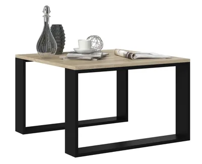 A modern coffee table with a wood-look top and black metal legs, shown with decorative items on top.