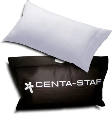 A white pillow is placed on top of a black bag with the brand name "CENTA-STAP" printed on it.