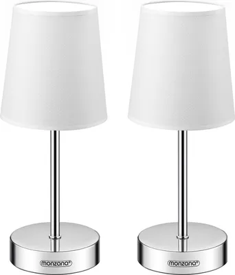 Two identical white table lamps with silver bases and stems are shown against a white background.