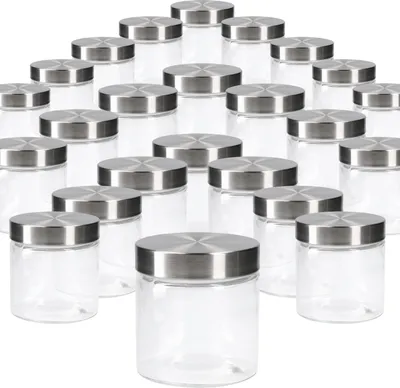 A collection of clear glass jars with silver lids arranged in rows on a white background.