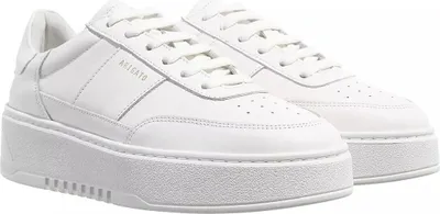 A pair of white leather sneakers with thick white soles, shown from a slightly elevated side angle against a white background.