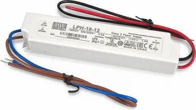 A white power supply unit with wires attached, lying on a white background.
