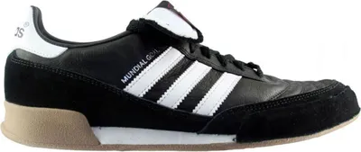 A side view of a black Adidas sneaker with white stripes and tan accents.
