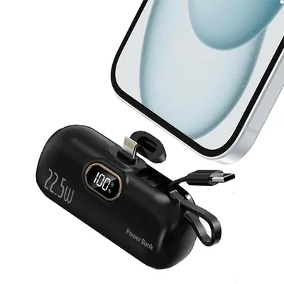A black mini power bank is shown next to a smartphone, with cables attached.